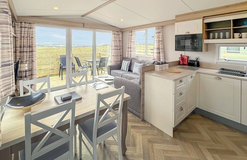 Castle Douglas House | 12ft-wide caravan situated in a coastal position.