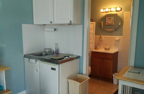 Stone Harbor Condo | 1st Floor Front Efficiency Unit, right side, corner Tables and chairs in the court yard.