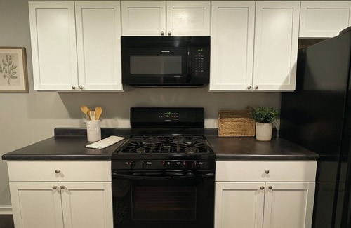 Michigan City House | 🛏 2 cozy bedrooms (1 King & 1 Queen) and 1 bathroom 🍳 Spacious kitchen stocked for cooking and dining in 🛋 Large living room for lounging after a long day. 🚗 Garage parking and easy access to town 🐶 Dog Friendly with Fully Fenced Ya