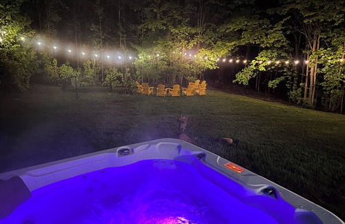 Traverse City House | 4bdr 2 bath house. Unwind in the hot tub, chat around the fire pit and disc golf