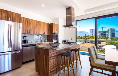 North Hotel Zone Condo | 5th-floor condo with partial ocean views, heated pool, sauna, gym, balcony, W/D