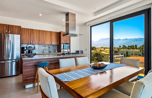 North Hotel Zone Condo | 5th-floor condo with partial ocean views, heated pool, sauna, gym, balcony, W/D