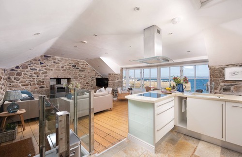 Mousehole Cottage | A beautifully refurbished stone cottage that sits right on Mousehole Harbour's waters edge.