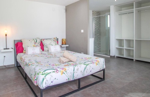 El Vendrell House | A large cottage with bright interior and private outdoor pool, next to a covered terrace.