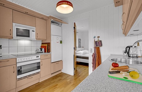 Helnæs By House | A simple cottage with terrace and bright living room.