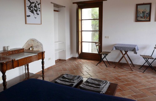 Seggiano House | Apartment with double bed, bathroom, small kitchen and large terrace.