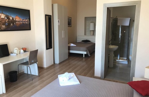 Esquilino Bed & Breakfast | Aria Rome Rooms triple room with balcony view of Basilica di San Giovanni