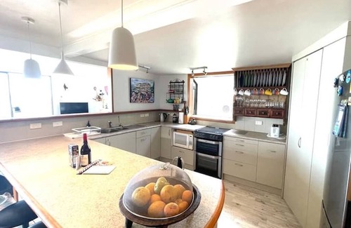 Wainui House | Awesome Wainui Spacious Holiday Home Overlooking the Surf - no pets.