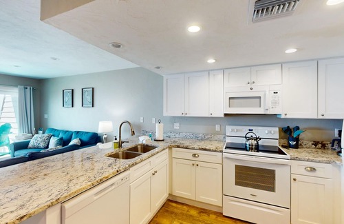 East End House | Beachfront East End townhouse with beach views, deck, on-site pool & grills