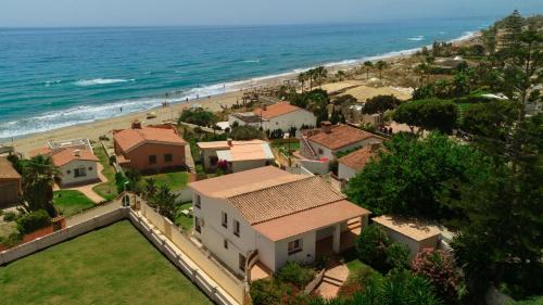 Urbanizacion Costabella House | Beachfront with Private Terrace, Garden, BBQ, and Garage in Marbella
