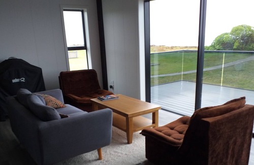 Waiotahi House | Big Black Beachfront Bach in family friendly community.
