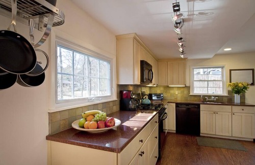 Woodstock House | Brookside Retreat: streamside patio outdoor fireplace fenced yard walk to town!