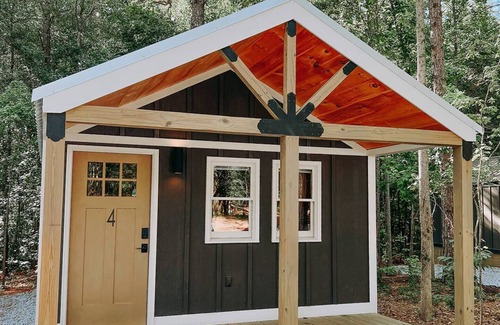 Hartwell RV Rental | Cabin #4: Two queen-size beds with a kitchenette and a large gravel parking pad beside the cabin for easy boat or trailer storage.