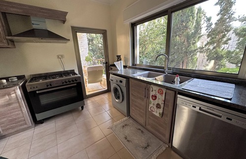 Amman Apartment | Centrally Located Bright 2 BR Apartment with Breathtaking Tropical Tree Garden!