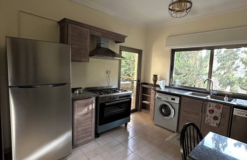 Amman Apartment | Centrally Located Bright 2 BR Apartment with Breathtaking Tropical Tree Garden!