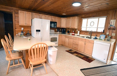Prudenville Cottage | Centrally located, four season retreat w/firepit and lakeview.
