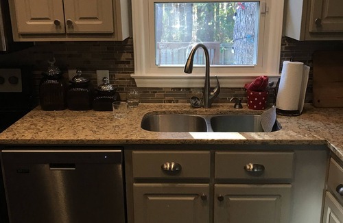 Hillsborough House | Charming brick ranch with spacious fenced yard.