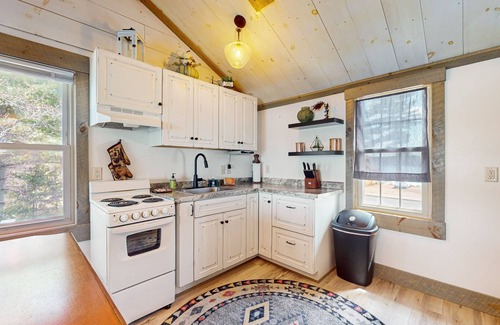 Arbor Vitae Cabin | Charming lakefront cabin with fireplace, cozy interior, streaming, & partial AC