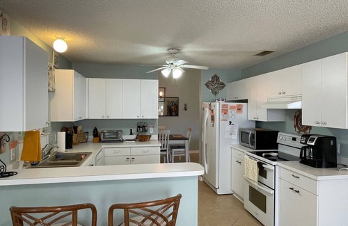 Lady Lake House | Charming Retreat with Lanai & Preserve Views, Golf Cart Included!