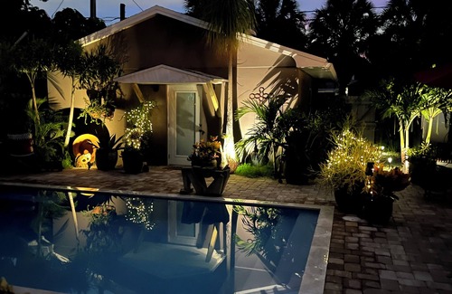 Parrot Cove Cottage | Chill on the patio overlooking the pool & lush gardens with privacy!