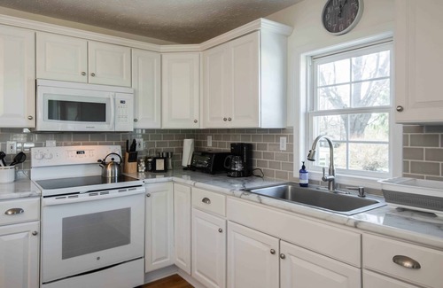 Hendersonville Cottage | Classic white farmhouse style cottage. Perfect for a serene country getaway.