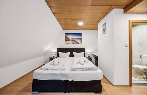 Wilhelmshaven Hotel | Comfortable room with a double and single bed, private bathroom, flat-screen TV, fridge, microwave, coffee machine, and cozy seating area. Ideal for small families or friends traveling together.