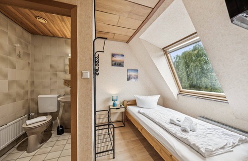 Wilhelmshaven Hotel | Comfortable room with a double and single bed, private bathroom, flat-screen TV, fridge, microwave, coffee machine, and cozy seating area. Ideal for small families or friends traveling together.