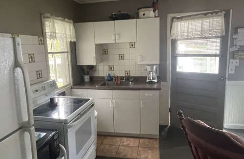 Ludington Cottage | Cottage 3 is a charming 2 bedroom 25’ from your boat dock & Hamlin lake.