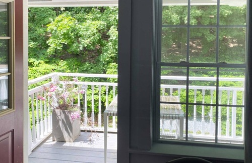 Lenox Bed & Breakfast | Cozy Carriage House room with a double bed and private balcony