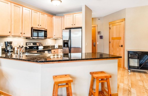Three Lakes Condo | Cozy condo w/ lake-view, balcony, fireplace, pool, game room, & washer/dryer