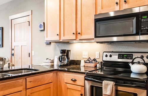 Three Lakes Condo | Cozy condo w/ lake-view, balcony, fireplace, pool, game room, & washer/dryer