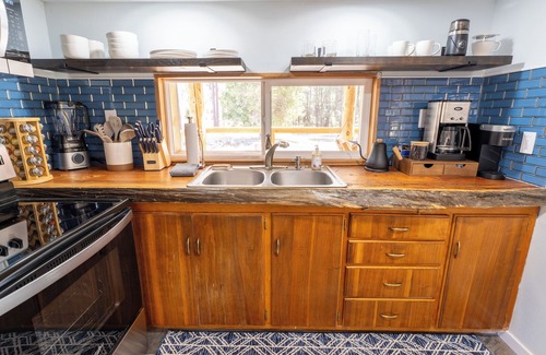 Springville Cabin | Cozy rustic cabin nestled in the woods near Peppermint Falls.