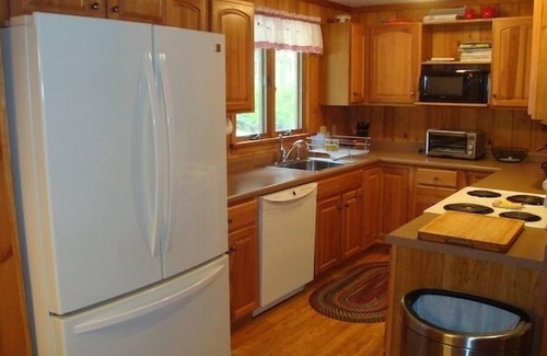 Harrison House | Cozy waterfront cottage on private land with beautiful sunsets over Long Lake