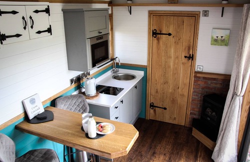Newcastle-on-Clun Cabin | Cwm Cariad - Shepherds Hut with Hot Tub Sleeping 2 guests, Pet Friendly