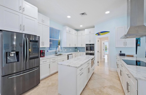 Palm City House | Deep water front home with private dock, pool, outdoor kitchen and pool table.