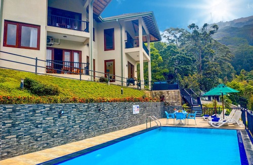 Kandy Villa | Deluxe Family room with balcony and mountain view.