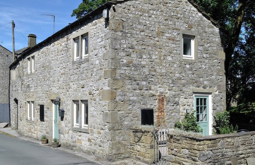 Kettlewell Cottage | Detached barn conversion with side terrace overlooking the river.