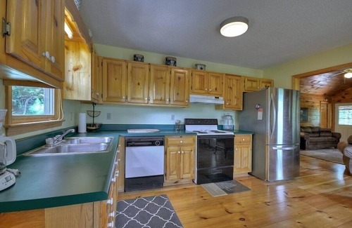 Ellijay Cabin | Discover River Bluff Retreat, a Pet-friendly haven with riverfront access for tubing and fishing, plus hot tub, outdoor fireplace, dock, and WiFi.