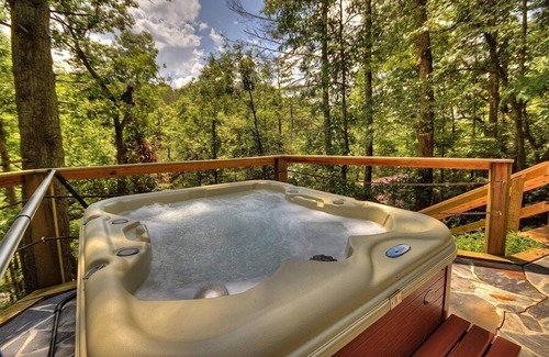 Ellijay Cabin | Discover River Bluff Retreat, a Pet-friendly haven with riverfront access for tubing and fishing, plus hot tub, outdoor fireplace, dock, and WiFi.