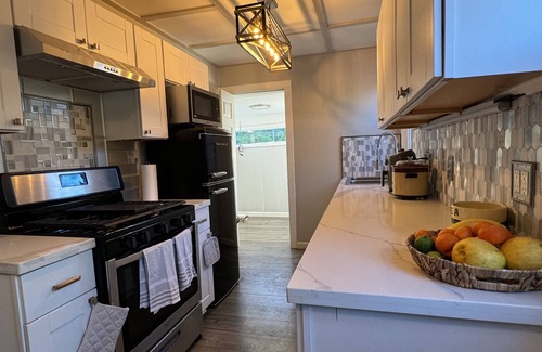 Sunland House | Dog friendly cottage with porch, pool, massive yard, and plenty of parking.