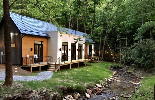 Scaly Mountain House | E Ranch is a modern, creek side, Scandinavian barnhouse.