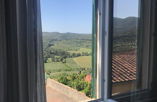 Castagneto Carducci Apartment | Elegant apartment in the historic village, with ceiling beams and splendid views