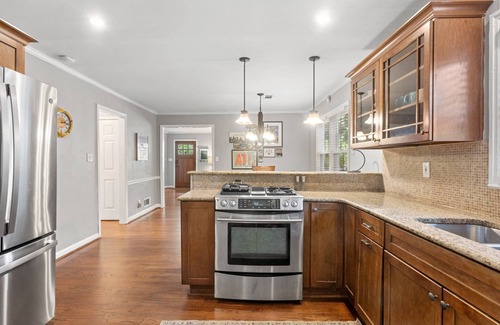 East Side House | Embark on a Grant Park Retreat: Zoo Proximity, Fire Pit Relaxation, and Lion-Sized Dinner Ambience