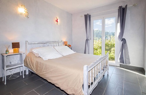 Cargese Apartment | Enjoy an enchanting view of the countryside in this appealing vacation apartment near the sea.