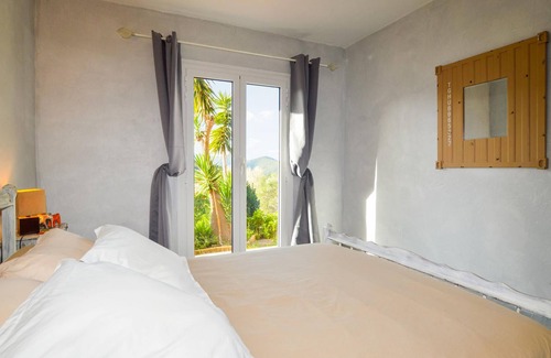 Cargese Apartment | Enjoy an enchanting view of the countryside in this appealing vacation apartment near the sea.
