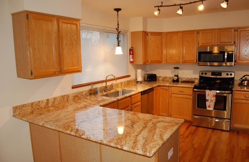 Northeast Colorado Springs House | Enjoy the large patio and shaded back yard of this large home with 2 kitchens