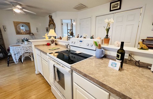 Colonial Beach House | Enjoy the screened side porch, covered front porch, the quick walk to the Beach