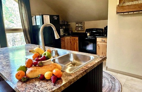 Island Park House | Enjoy the spacious vaulted ceilings with a full kitchen and open concept living!