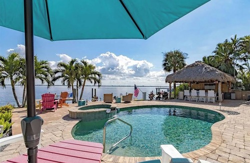 Caloosahatchee House | Expansive Riverfront Home. Heated pool spa. LargeTiki Bar & Outdoor Kitchen.