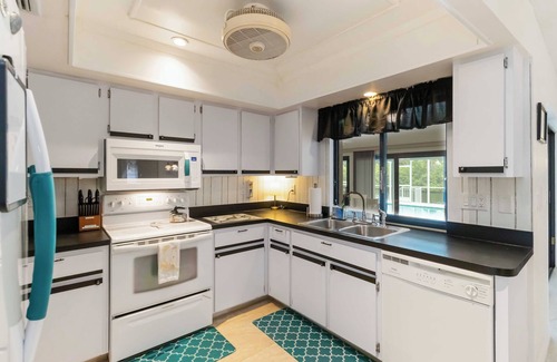 Port Charlotte House | Experience serenity in this fully furnished 3-bed, 3-bath waterfront home featuring a heated pool, spacious layout, and abundant natural light. Enjoy stunning water views from the master suite, living room and Florida room.